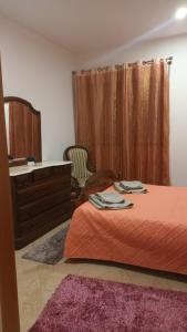 a bedroom with a bed and a dresser and a dresser at Pousada starlite in Regilde