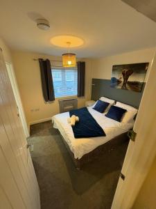 a bedroom with a bed with a teddy bear on it at Spacious 3-Bed House - Sleeps 8 Garden & Parking in Peterborough