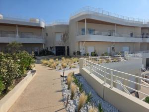 a building with a row of plants in front of it at Bel appartement avec vue mer in Le Trayas