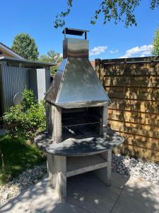 an outdoor grill is sitting in a yard at Newly renovated 2 bedroom holiday home in Cheyres in Cheyres