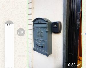 a blue mailbox on the side of a building at Hotel Isolabella in Bussoleno