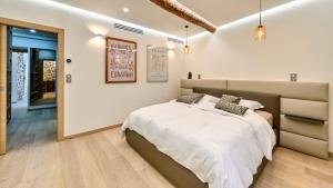 a bedroom with a large bed with white sheets at Le Palais Aubernon in Antibes