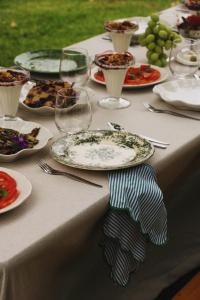 a table with plates of food and wine glasses at Quinta Amarela - B&B in Nazaré