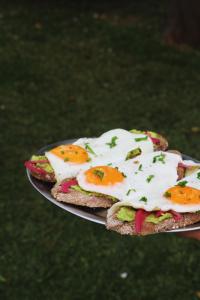 two slices of bread with eggs on top on a plate at Quinta Amarela - B&B in Nazaré