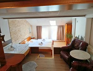 a bedroom with a bed and a couch in a room at Spa & Pool Apartments Prestige VILLA IVICA in Bratislava