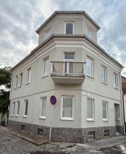 a large white building with a balcony on top of it at Apartmány Hviezdoslavova in Piešťany