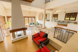 a living room with a red chair and a couch at Spacious villa in Founty, beach side 40m front Sofitel in Agadir