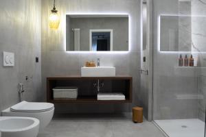 a bathroom with a toilet and a sink and a shower at Le Dimore del Centro in Bari