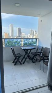 a table and chairs on a balcony with a view of a city at Hospedaje,Cartagena,Clasicos,Turismocolombia-fit in Cartagena de Indias
