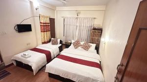 Voodi või voodid majutusasutuse Cherry Garden Pokhara toas