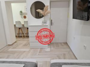 a white room with a free parking sign on the wall at Balance apartments in Koper