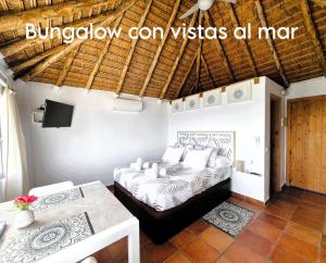 a bedroom with a bed and a table at Mandala Bungalows - Adults Only in Los Caños de Meca