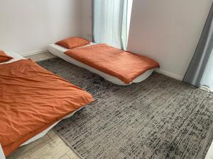 a bedroom with two beds and a window at Apartament Zoom 42 in Bydgoszcz