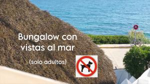 a sign on the side of a thatch hut at Mandala Bungalows - Adults Only in Los Caños de Meca