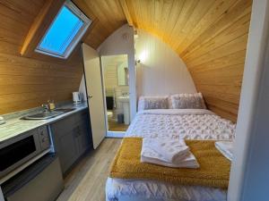 a bedroom with a bed and a sink in a room at Queensland Holiday Park - Glamping in South West Scotland in Barrhill