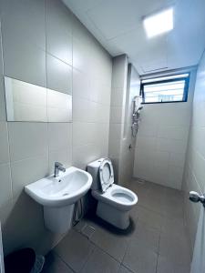 a bathroom with a toilet and a sink at Skyline Homes at i-City - WiFi TV Box 1 Carpark in Shah Alam +9 photos