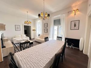 a dining room and living room with a table and chairs at Flanatika Residence Pula in Pula