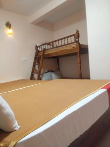 a bedroom with a bunk bed in a room at Farmdean holiday home in Kovakulam