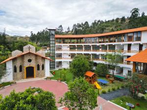 an aerial view of a building with a playground at Gran Kuntur Wasi Hotel Casa y Campo in Cajamarca