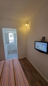 a living room with a flat screen tv on the wall at Apartament Onixy in Năvodari