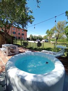 a large hot tub in a yard with a picnic table at Casale - La Camera di Leda in Lamporecchio +44 photos