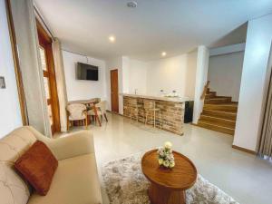 a living room with a couch and a table at Gran Kuntur Wasi Hotel Casa y Campo in Cajamarca
