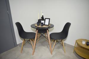 a table with two chairs and bottles of wine on it at Paul's Houses 2 in Drama