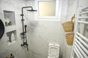 a small bathroom with a toilet and a window at Paul's Houses 2 in Drama +12 photos