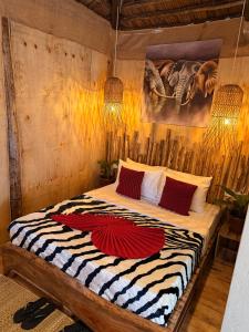 una camera da letto con un grande letto con una coperta zebra di Serengeti Home ad Arusha