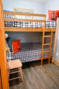 a room with two bunk beds and a chair at Muskoka Manor STR-2025-168 in Dwight