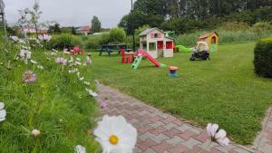 a backyard with a playground with a play area at Agroturystyka Wypoczynkowa II in Zieleniewo