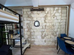 a room with a brick wall and a bunk bed at Séjour de charme, Notre-Dame, Hypercentre in Saint-Quentin +7 photos