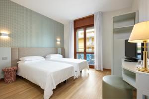 Кровать или кровати в номере Hotel Croce Di Malta