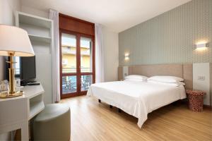 Кровать или кровати в номере Hotel Croce Di Malta