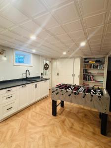 a kitchen with a table with wine bottles on it at Orleans Holiday House in Orleans