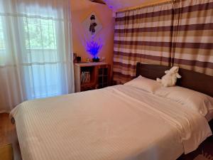a bedroom with a bed with a teddy bear on it at Casa Delia in Balta