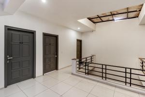 a hallway with two doors and a staircase at Townhouse South City 2 Sector 49 Gurgaon in Gurgaon