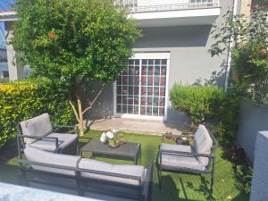 a garden with two chairs and a table and a tree at CASA DAS PEDREIRAS in Peso da Régua