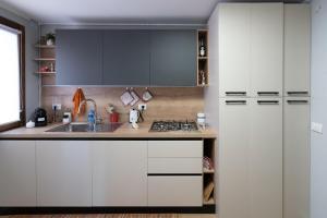 a kitchen with white cabinets and a sink at Suite delle Maree in Chioggia