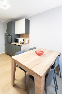 a kitchen and dining room with a wooden table and chairs at Suite delle Maree in Chioggia +17 photos