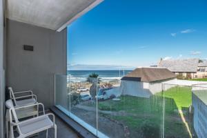 a balcony with a view of the ocean at Stylish Studio with Ocean Views at Wavescapes in Muizenberg
