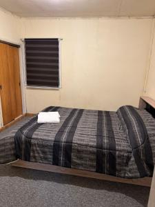 Postel nebo postele na pokoji v ubytování Casa Magallánica por día para Familia compuesta de 4 personas