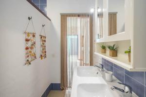 a bathroom with a sink and a mirror at Lightbooking La Graciosa in Caleta de Sebo +60 photos