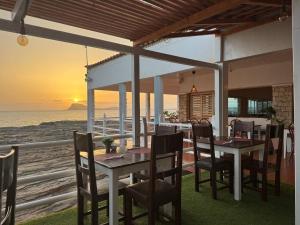a dining room with a table and chairs and the ocean at Murdeira V17 RC by RPG Group in Beirona