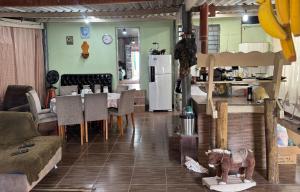 a living room with a couch and a table with a dog statue at Chácara Nhá Chica - Roseira - Aparecida - a 8km do Santuário Nacional in Aparecida