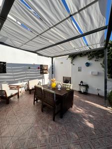 a patio with awning and a table and chairs at Dimora DiLeonardo in Carovigno