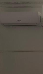a microwave oven on top of a ceiling at Studio in Fnidek +2 photos