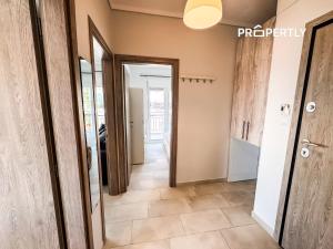 a hallway with a door and a tile floor at Blue Seaview Apartment #PROPERTLY in Nea Kalikratia +8 photos