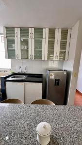 a kitchen with a counter top and a refrigerator at Hermoso Departamento Frente al Escuela de Oficiales de La policia in Lima +7 photos