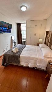 a bedroom with a large bed with a tray on it at Hermoso Departamento Frente al Escuela de Oficiales de La policia in Lima